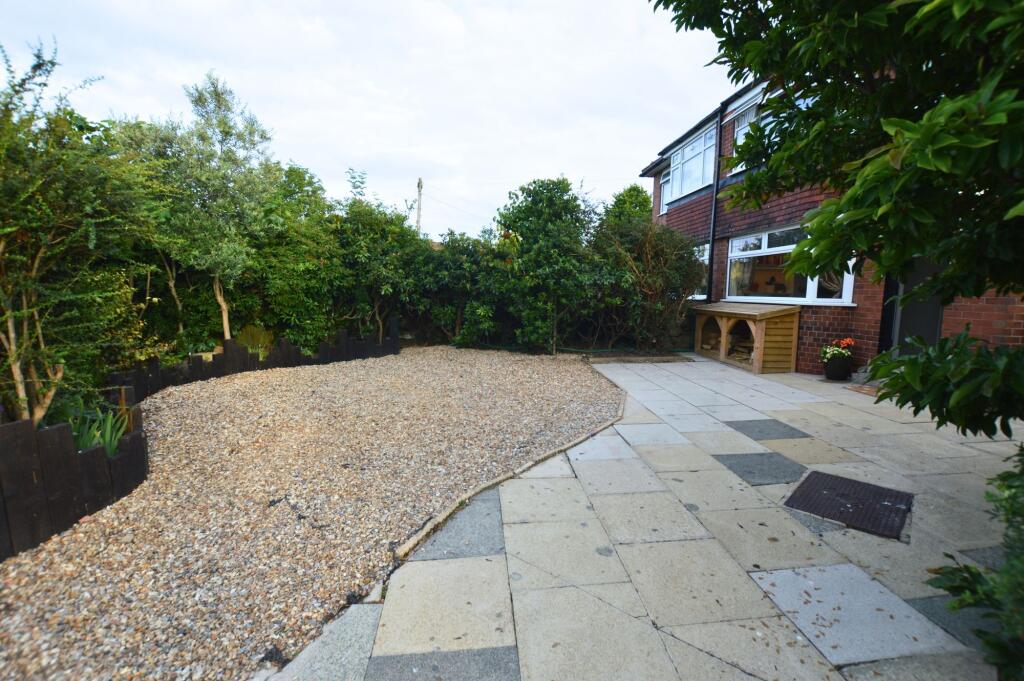 A spacious, well-maintained garden area with a ...