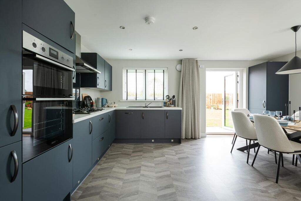 The spacious kitchen/dining area has double doors to the rear garden