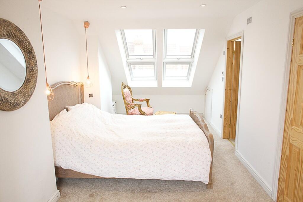 This charming double bedroom features ample nat...