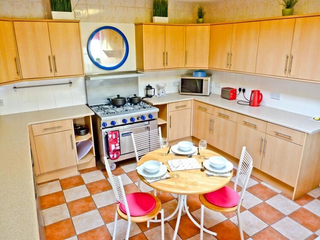 A bright and tidy kitchen featuring modern appl...