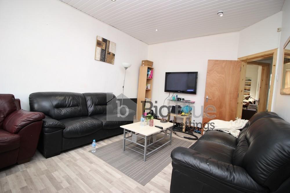 A comfortable living room featuring three black...