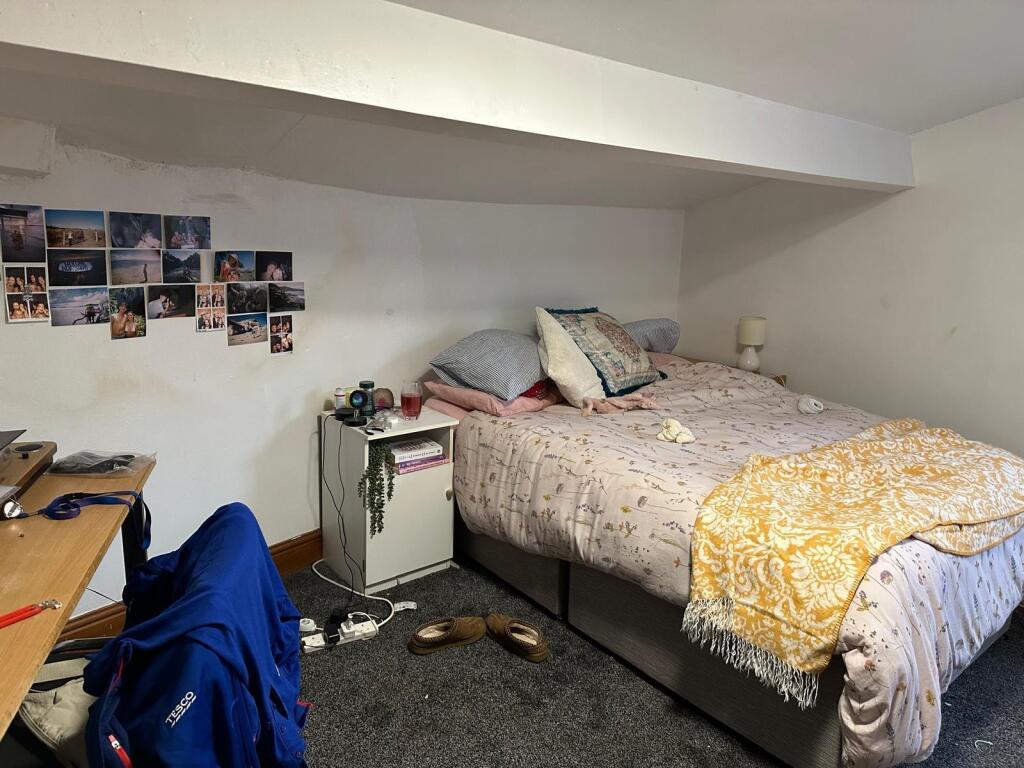 A comfortable bedroom featuring a double bed wi...