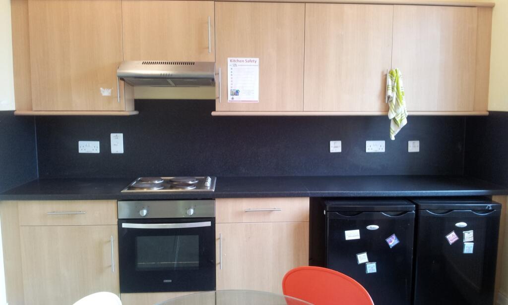 A tidy and functional kitchenette with modern a...