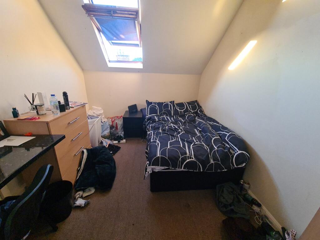 Cozy single bedroom featuring a comfortable bed...