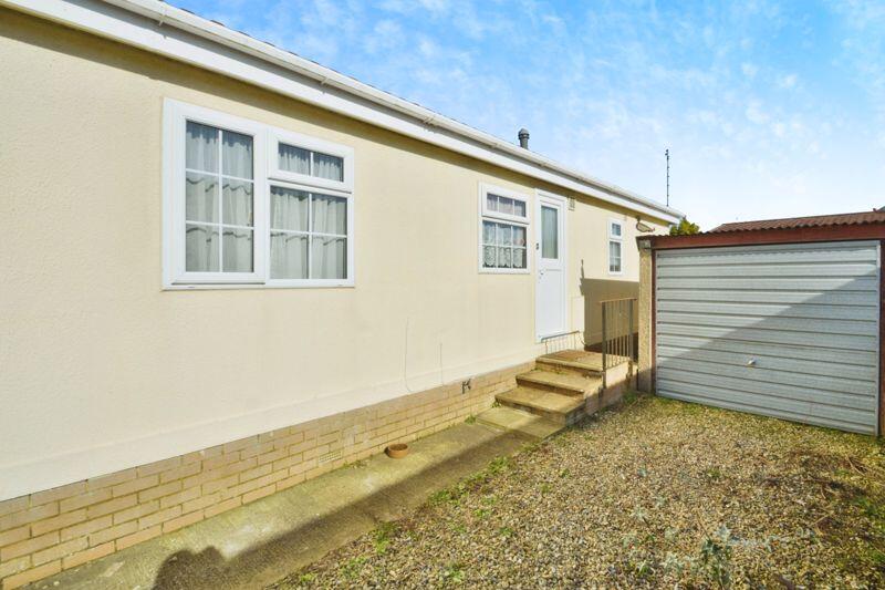 Driveway, garage and door into kitchen