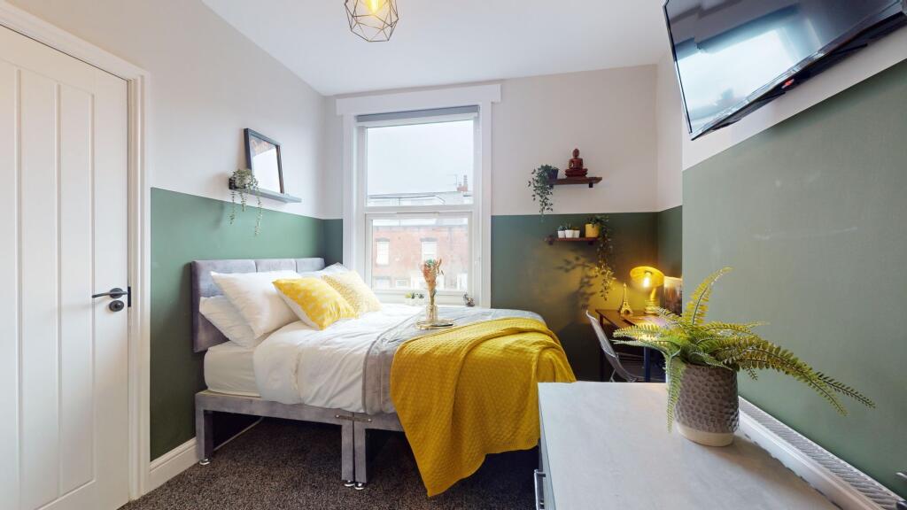This charming double bedroom features a cozy la...