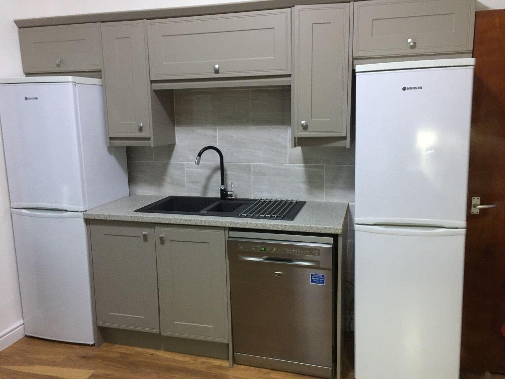 Modern compact kitchen with matching cabinetry,...
