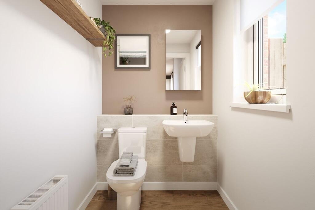 A handy downstairs toilet sits off the dining area