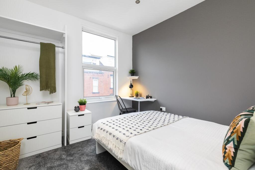 Bright, stylish bedroom with a comfortable doub...