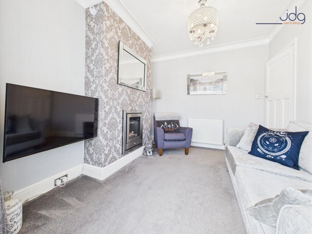 Lounge with bay window and a modern feature fireplace