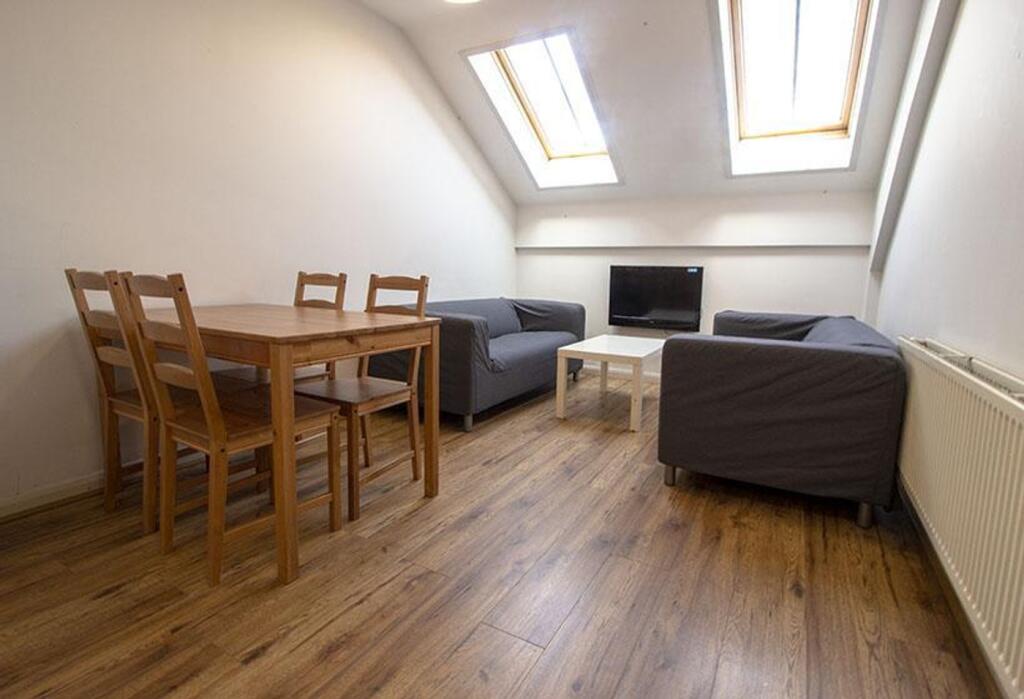 A cozy living room featuring ample natural ligh...