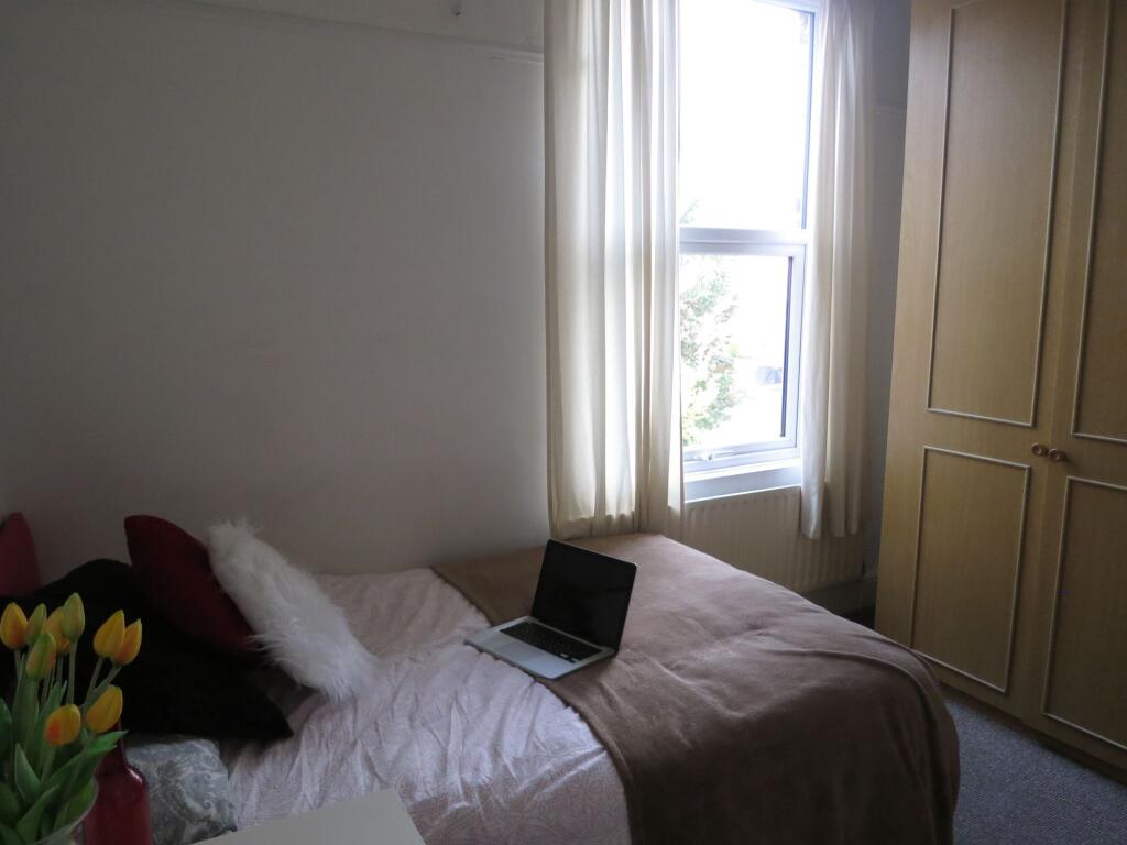 A cozy, well-maintained double bedroom with a c...