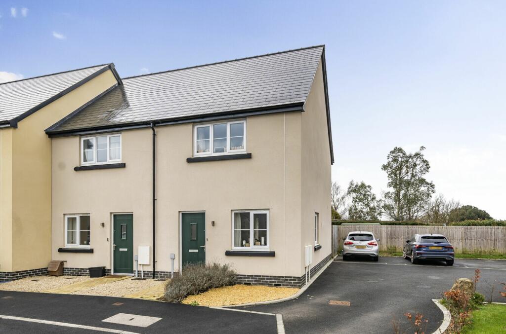 Front of house and two parking spaces