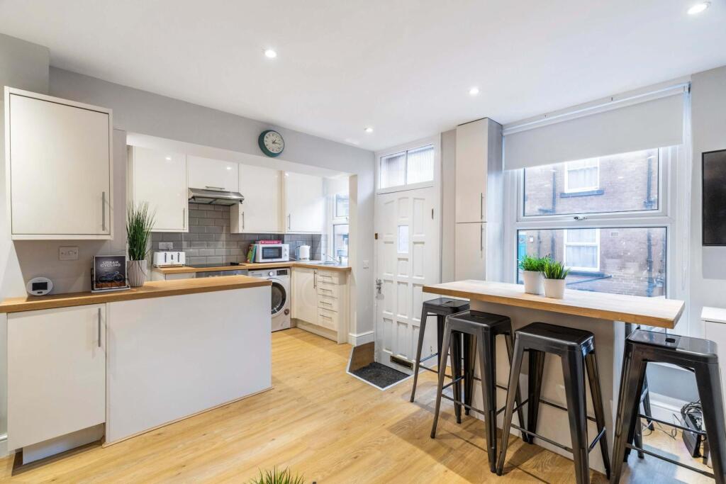 Bright and spacious kitchen area featuring larg...