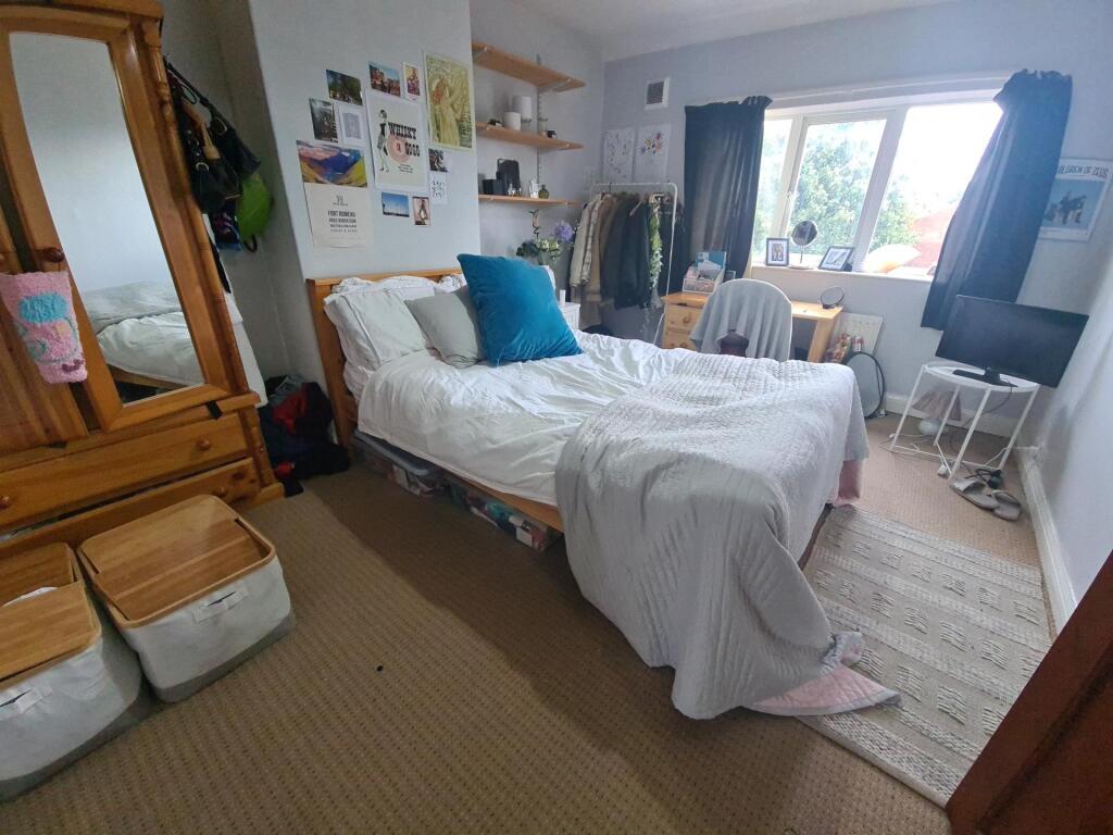 Bright and welcoming bedroom featuring a spacio...