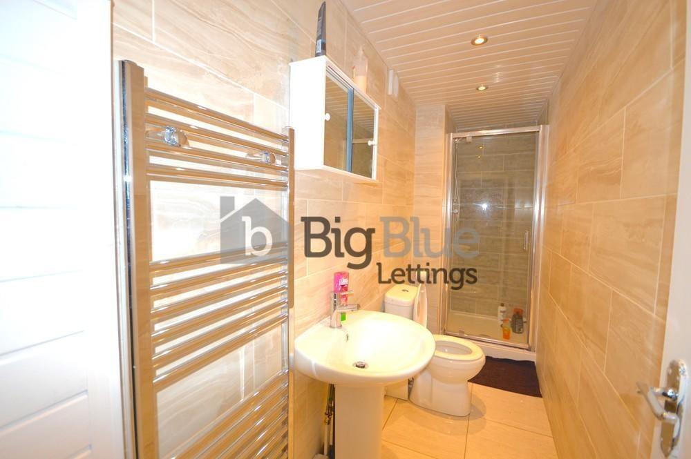 Bright and modern bathroom suite featuring a wa...