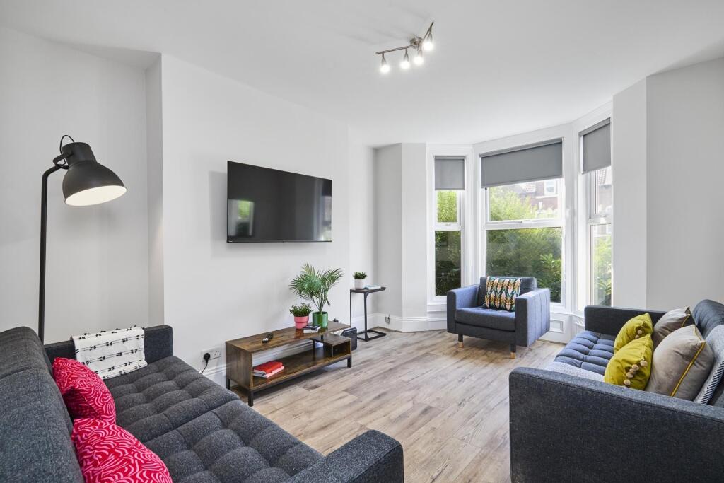 Bright, modern living room with bay window lett...