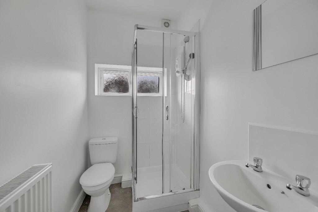 Bright and clean bathroom featuring a modern sh...