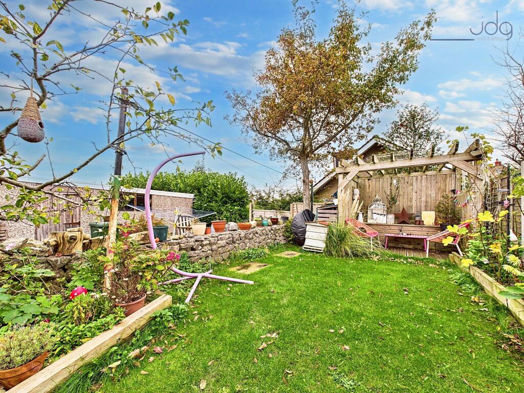 A ginnel separates the yard from the property¿s private garden opposite