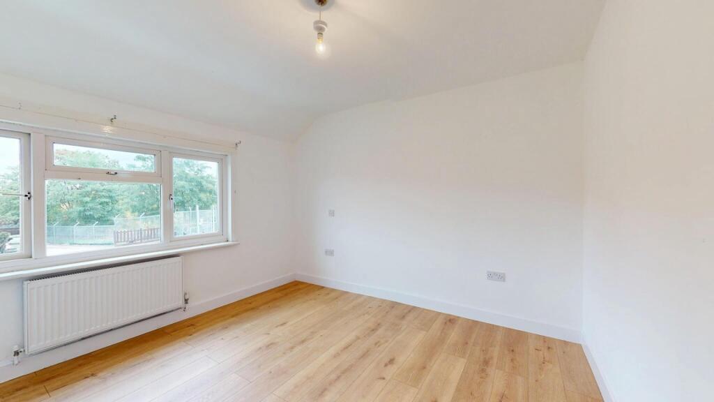 A bright and spacious living room featuring lar...