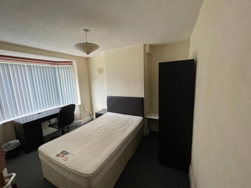 Bright and cozy single bedroom featuring a comf...