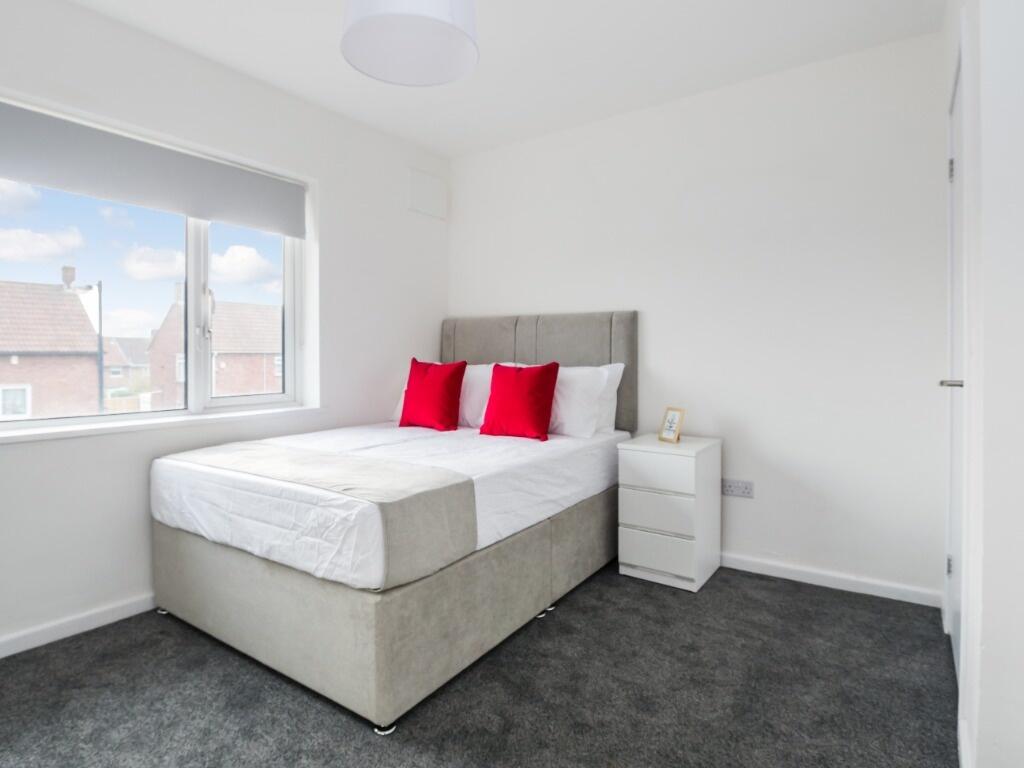 Bright and modern double bedroom featuring a co...