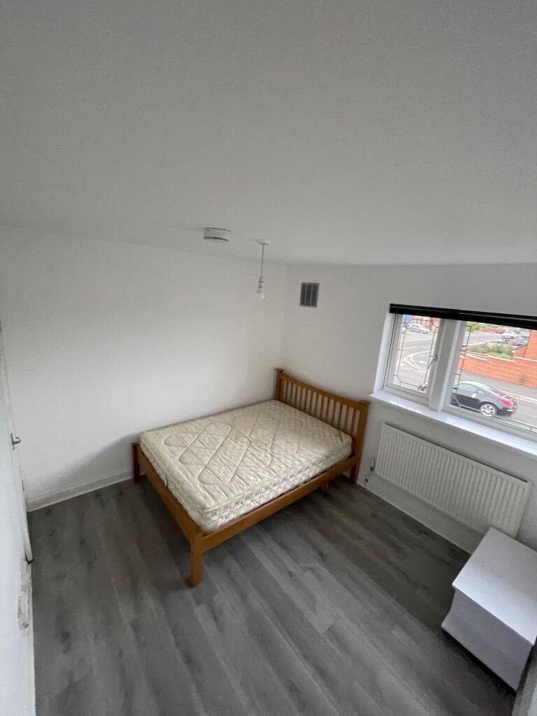 A neat and bright double bedroom featuring a wo...