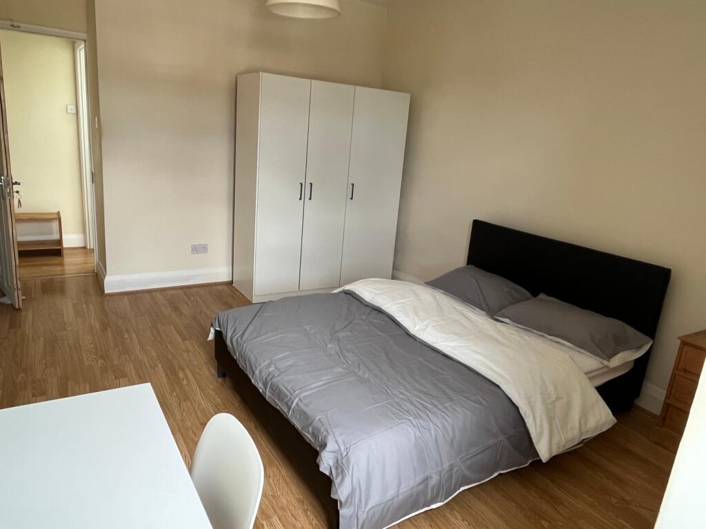This inviting double bedroom features a comfort...