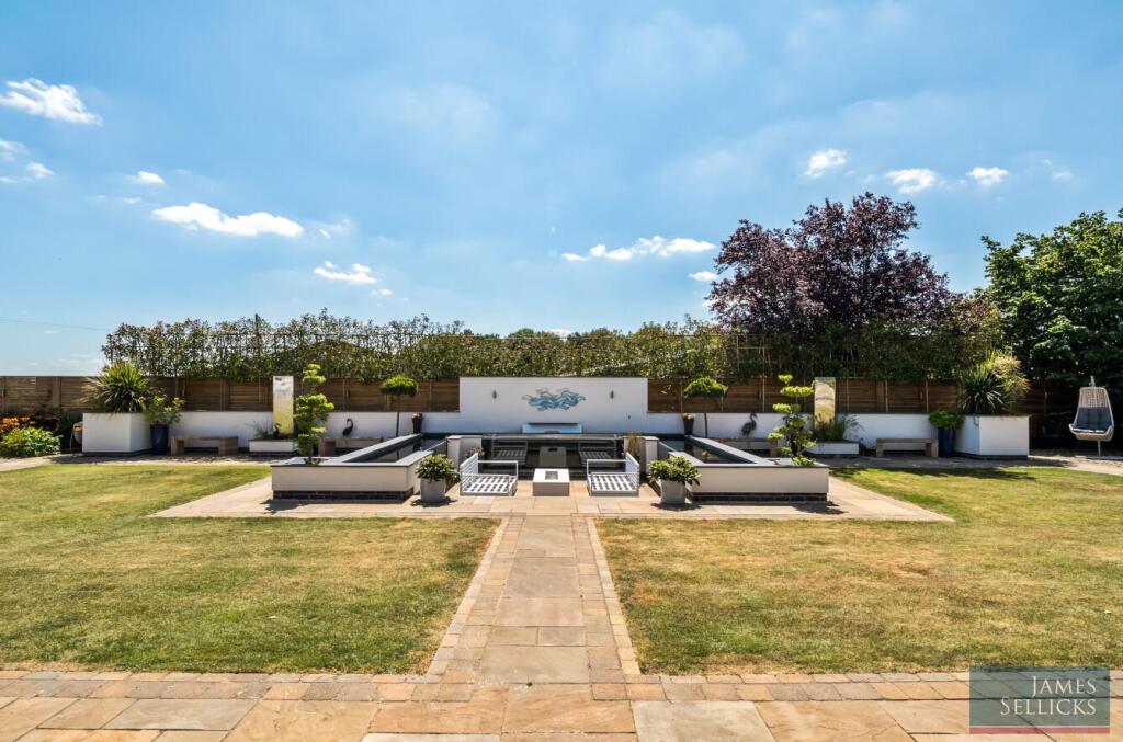 Sunken seating terrace with raised Koi Carp ponds