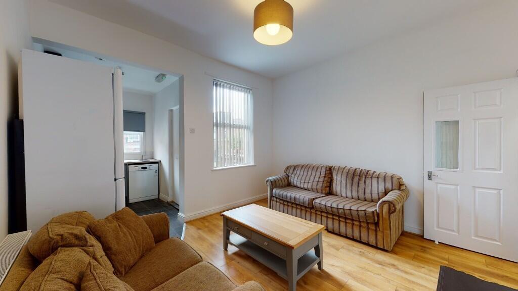 A bright and welcoming living room featuring co...