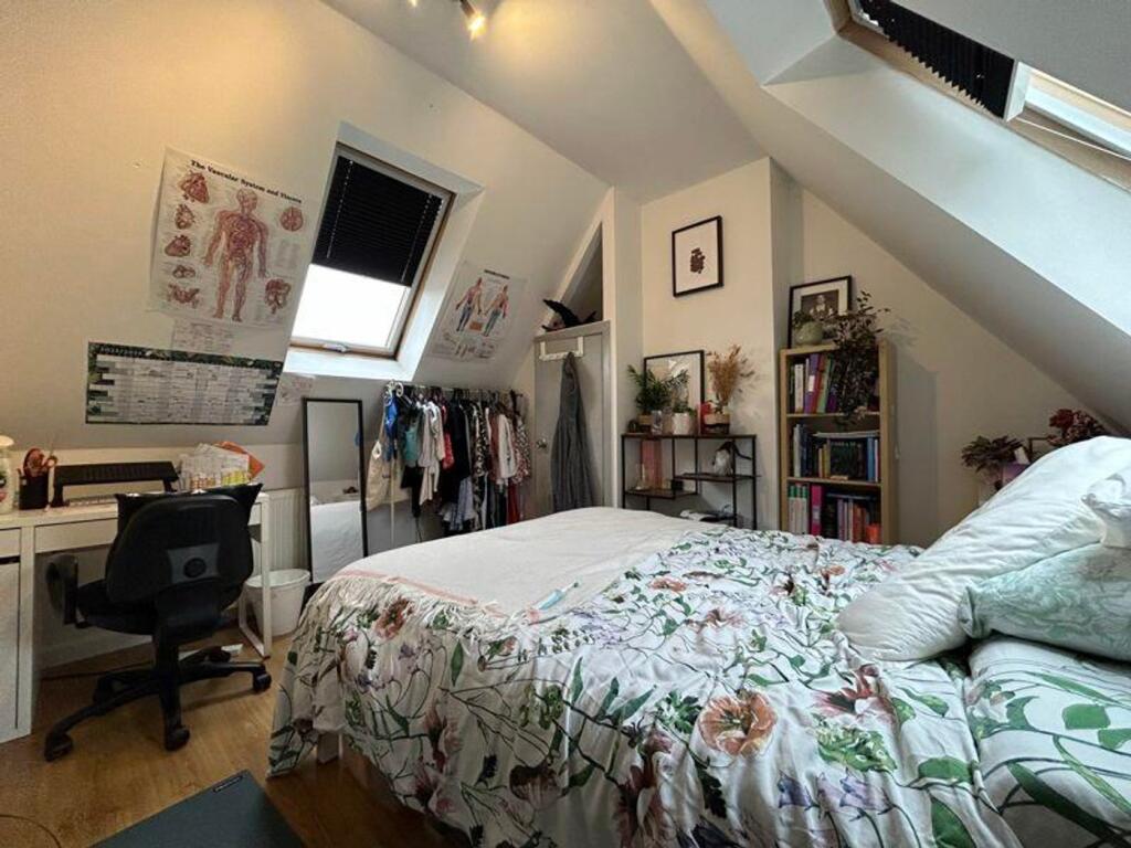 A bright and inviting double bedroom featuring ...