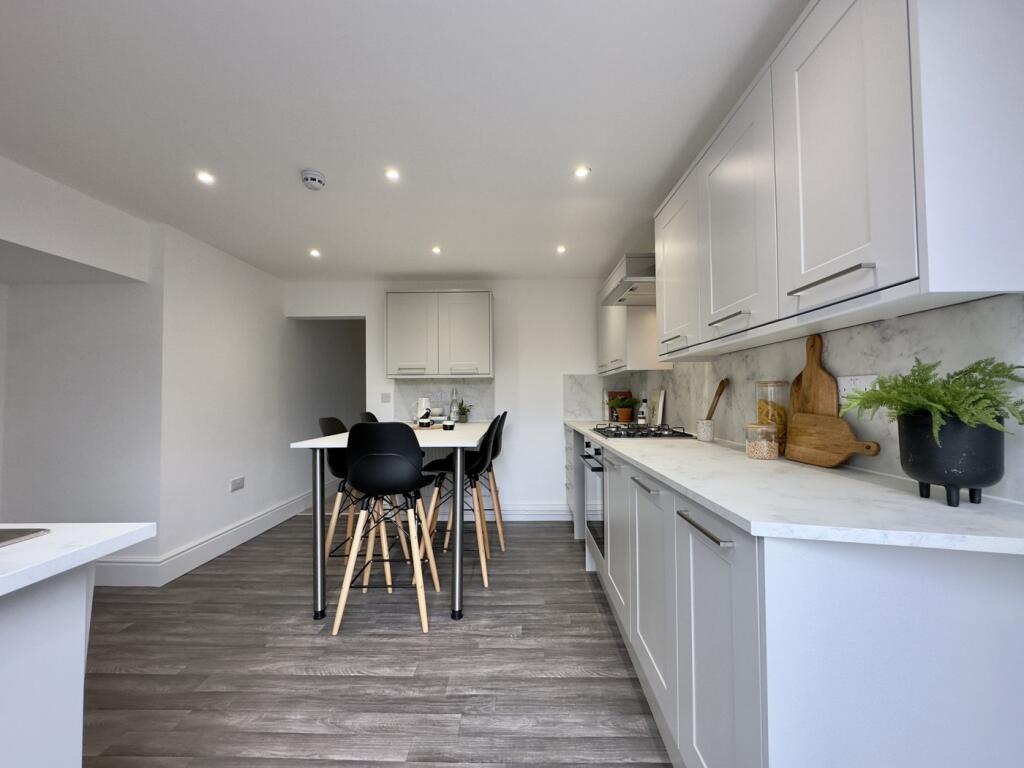 A modern and spacious kitchen with ample natura...