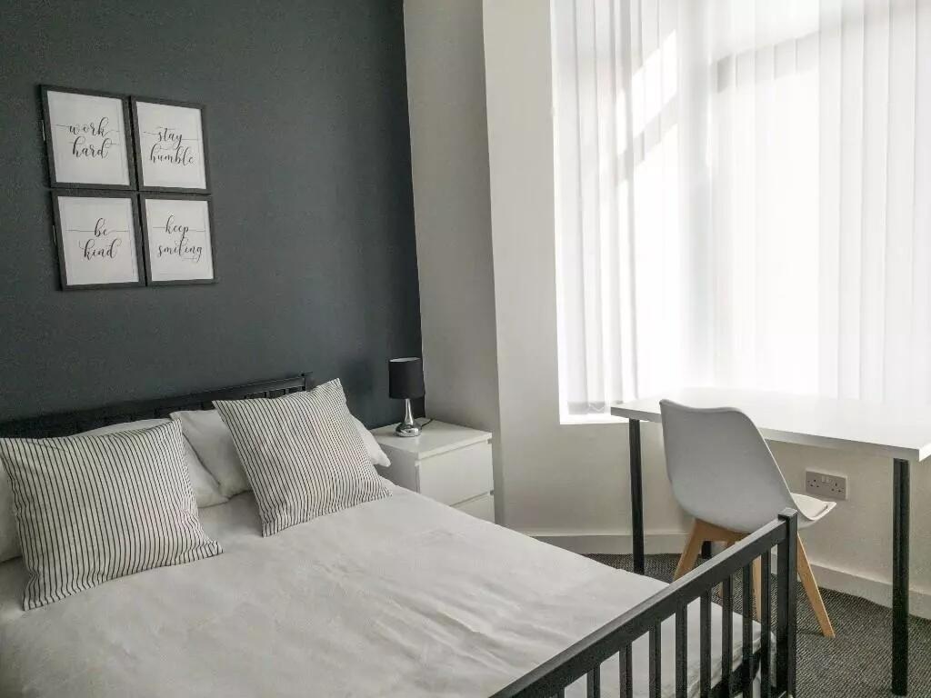 A stylish double bedroom featuring a comfortabl...