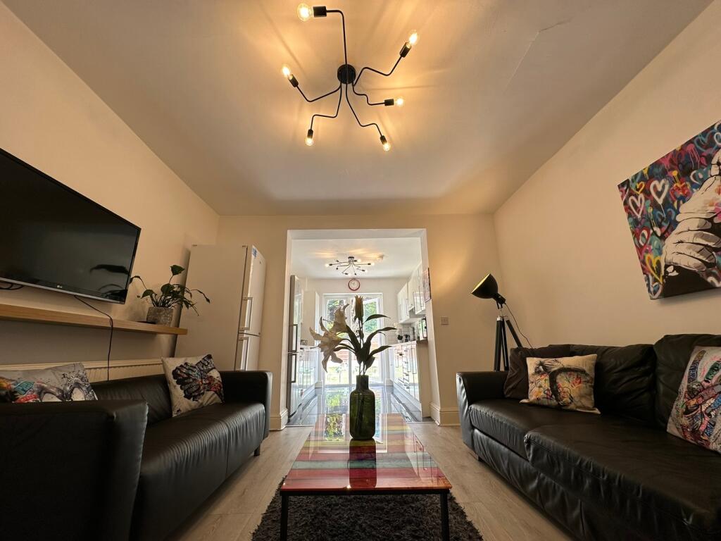 A stylish and spacious living room featuring mo...