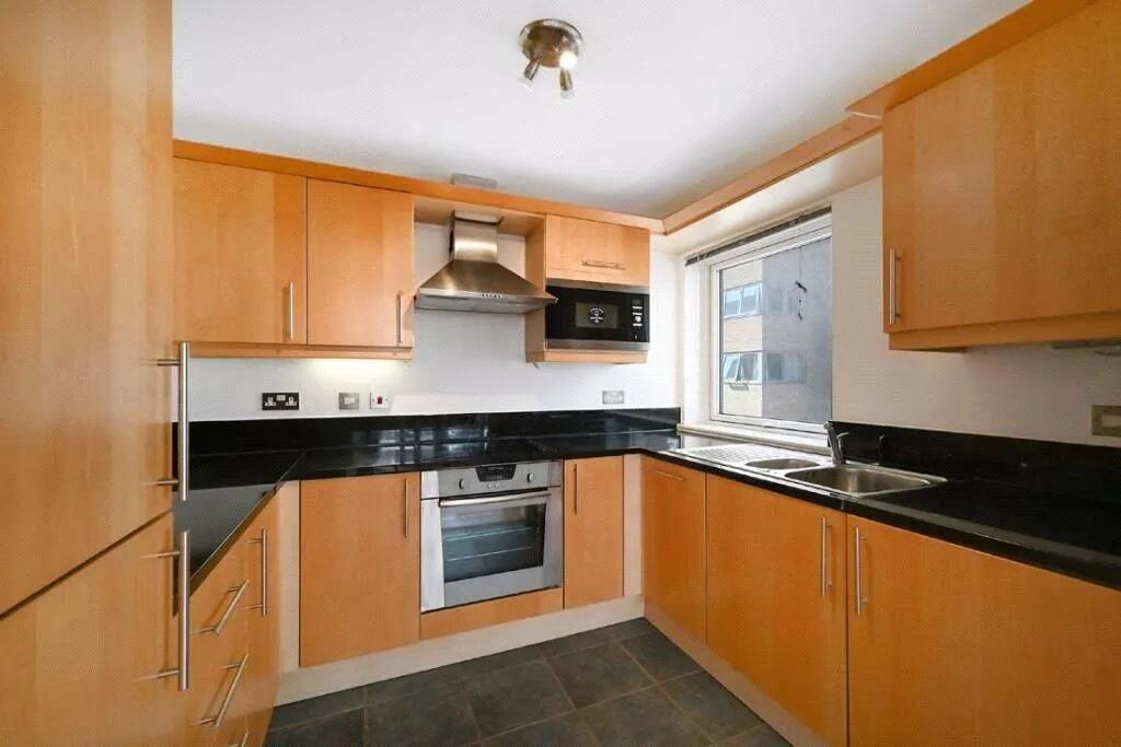 Bright and modern kitchen featuring ample cabin...