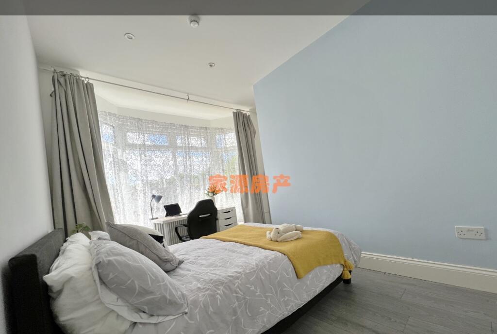 Bright and airy master bedroom featuring a comf...
