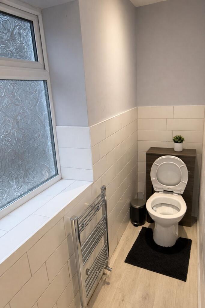 Bright, modern WC with frosted privacy window, ...