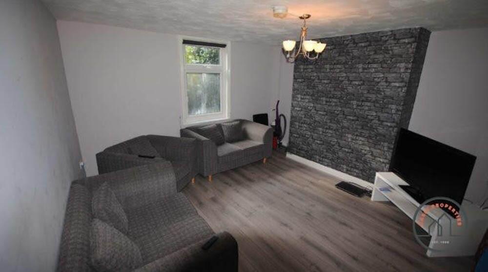 A cozy living room featuring modern grey sofas,...