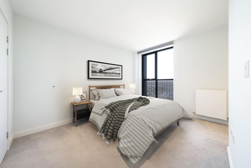 Experience tranquility in this bright and inviting bedroom, designed for restful nights.