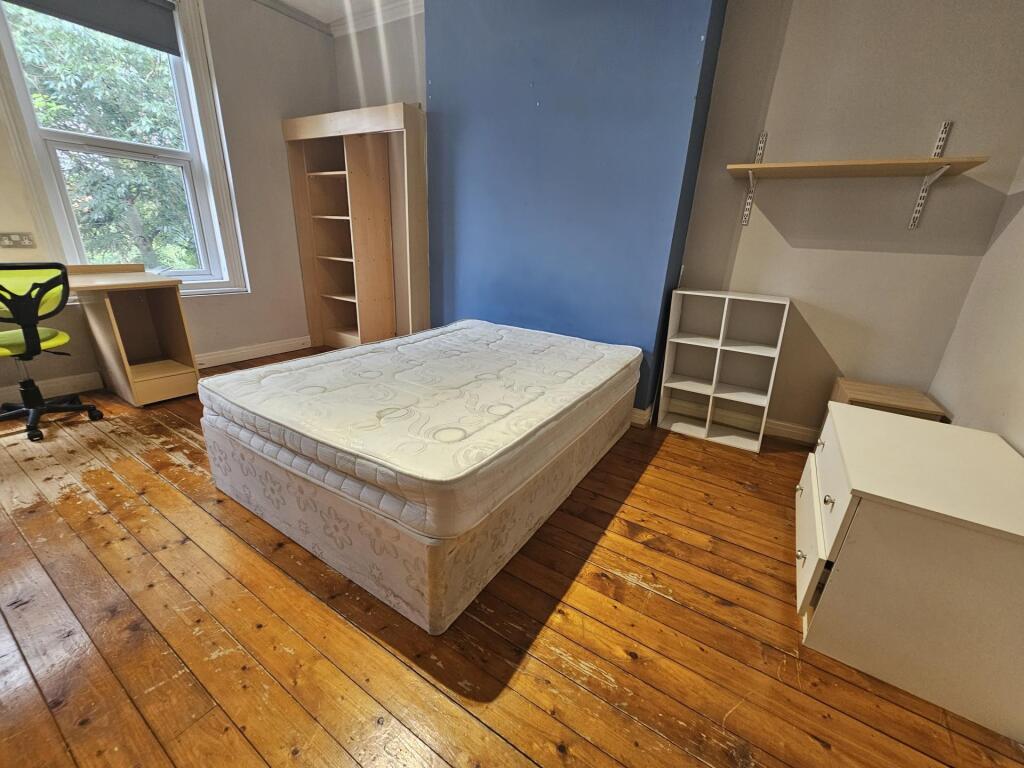 Bright, well-presented bedroom with wooden floo...