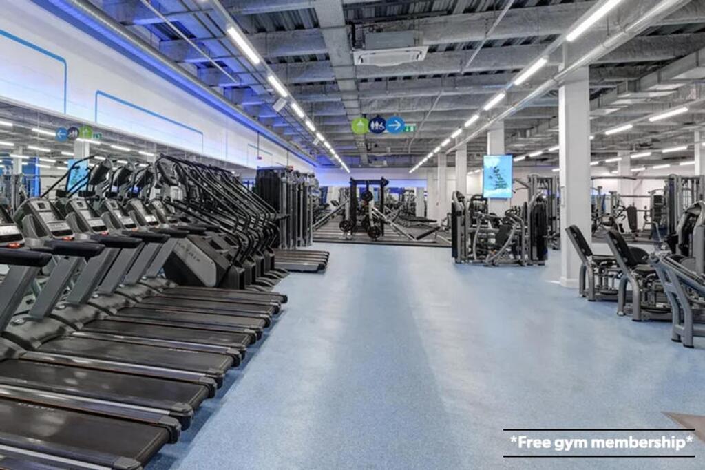 A spacious and modern gym featuring a variety o...