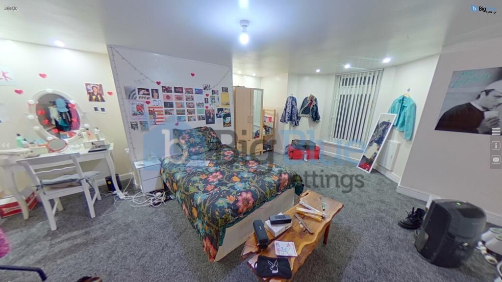 A cozy and spacious master bedroom featuring a ...