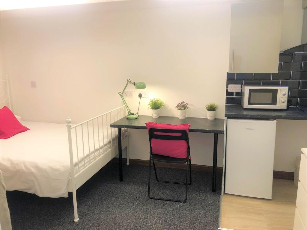 Bright and tidy single bedroom featuring a cozy...