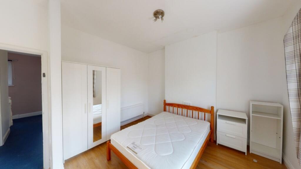 A spacious and well-lit double bedroom featurin...