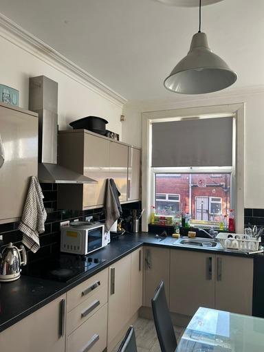 A modern kitchen with a large window providing ...