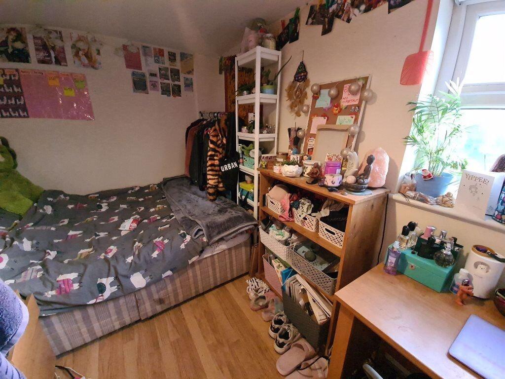 Cozy and well-organized bedroom featuring a com...