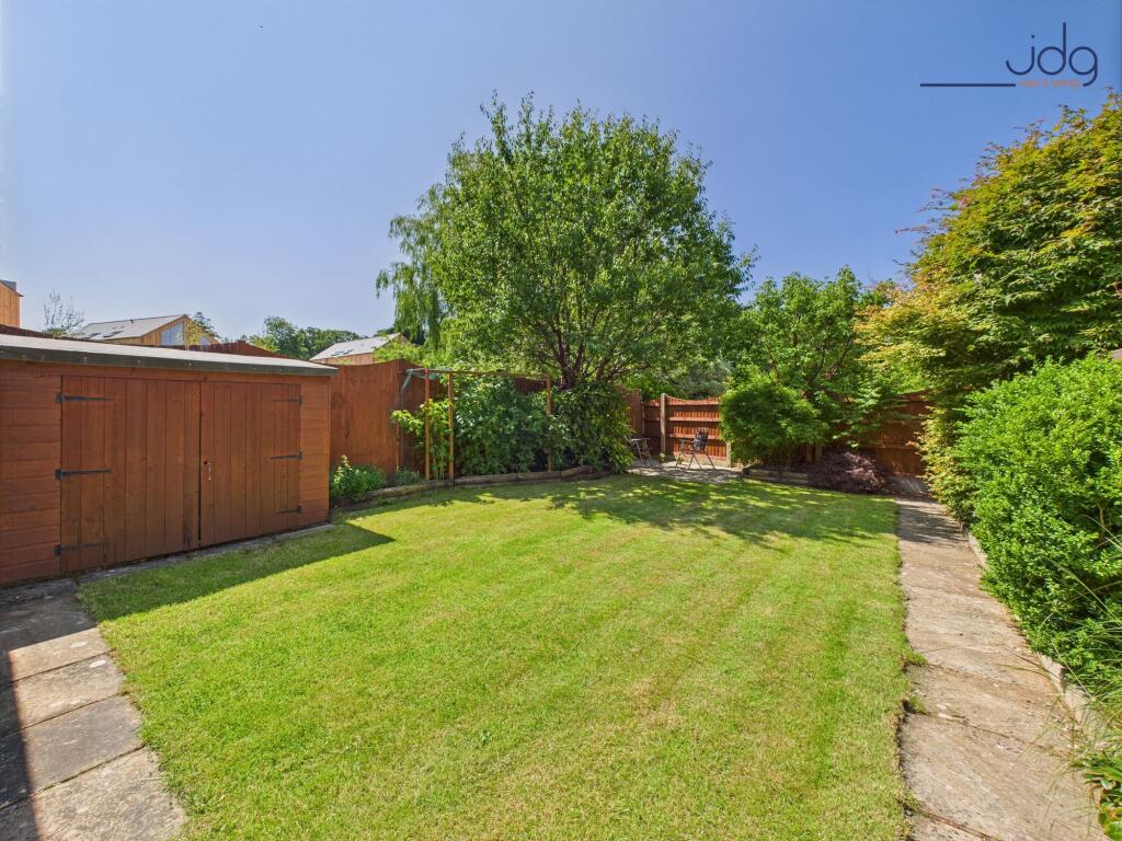 Spacious rear garden with mature plants and boarders