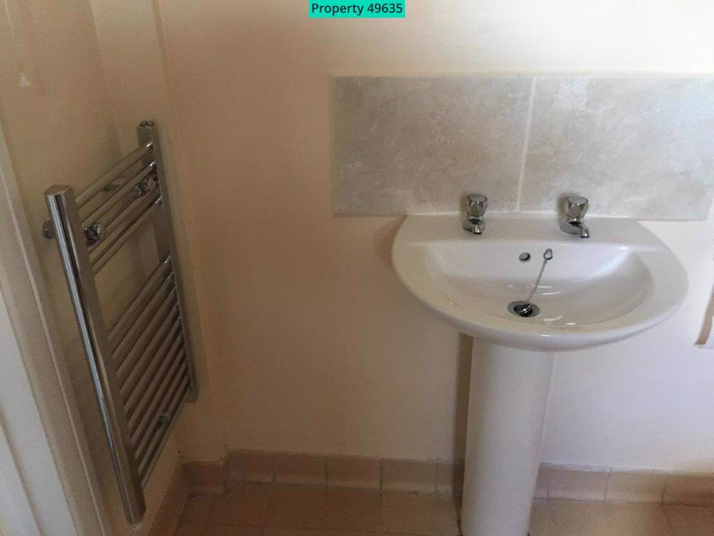 Heated towel rail and sink in shower room