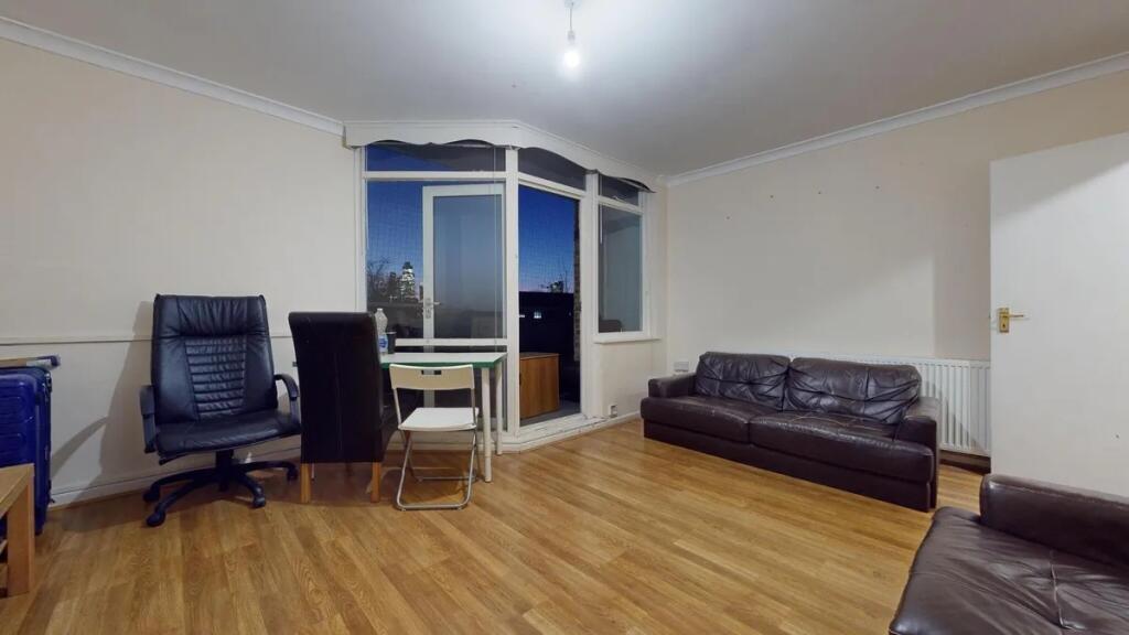A comfortable living room featuring two dark le...