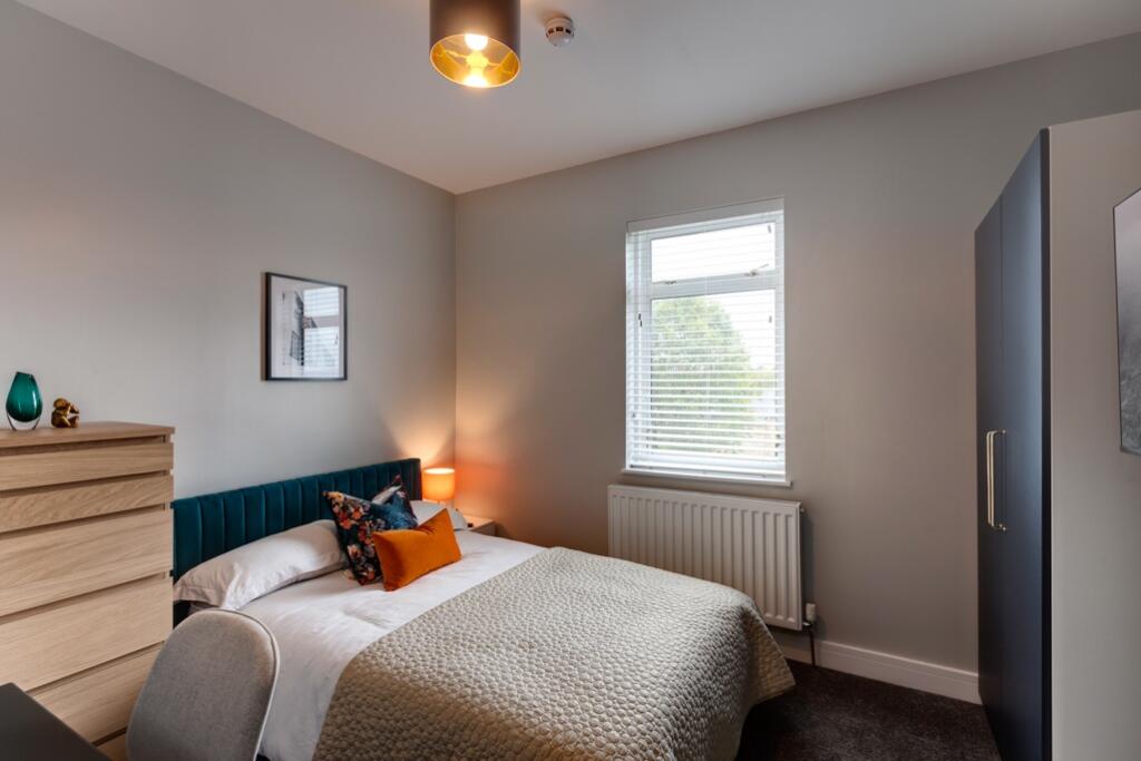 A stylish and comfortable double bedroom featur...